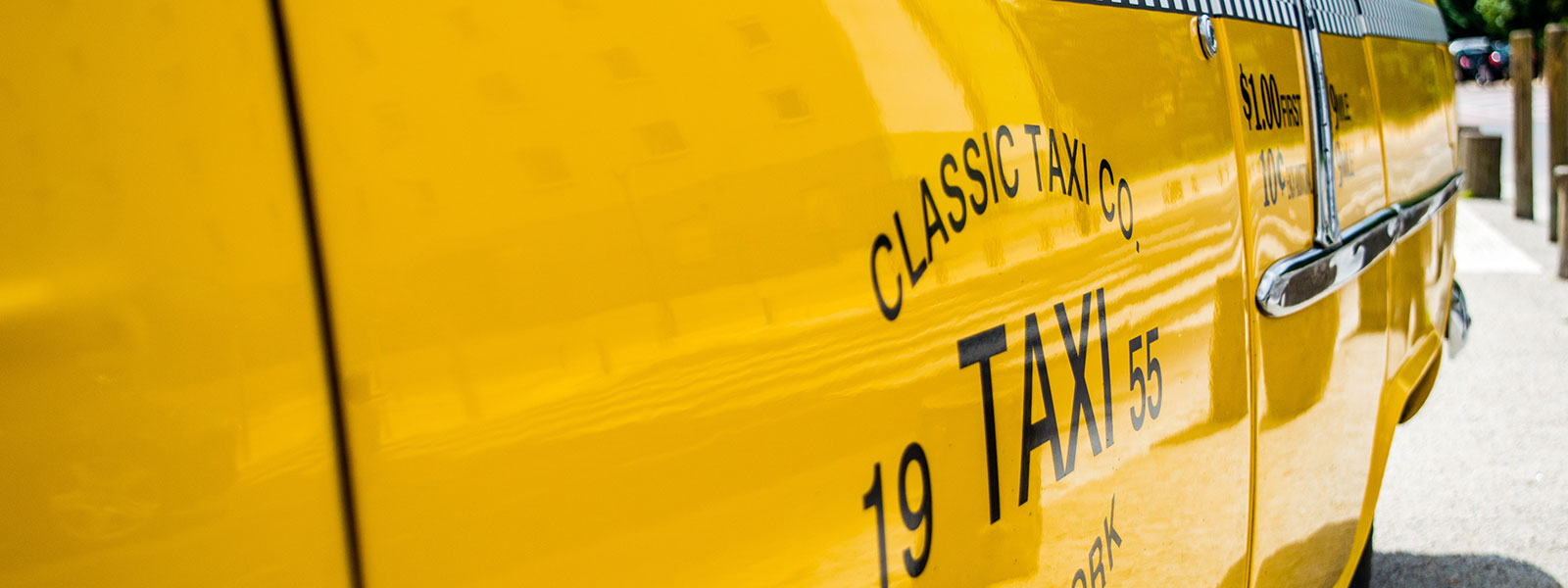 The side of a classic New York City taxi cab.